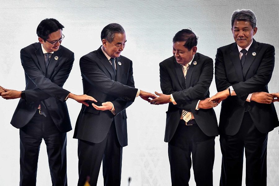 (Left to right) Vietnam’s Deputy Minister of Foreign Affairs Do Hung Viet, China’s Foreign Minister Wang Yi, Myanmar’s Permanent Secretary of Foreign Affairs Aung Kyaw Moe, Malaysia’s Foreign Minister Mohamad Hasan pose for a photo during the ASEAN Post Ministerial Conference with China at the Association of Southeast Asian Nations (ASEAN) summit in Vientiane on 26 July 2024. (Sai Aung Main/AFP)