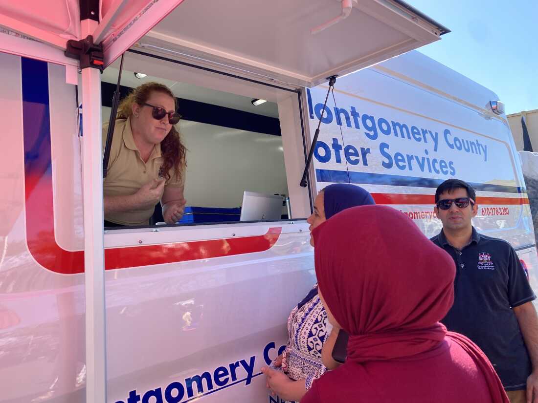 Montgomery County Commissioner Neil Makhija (right) shows off a new voting van during a neighborhood fall festival. People can register to vote at the van and cast their ballots on the spot.