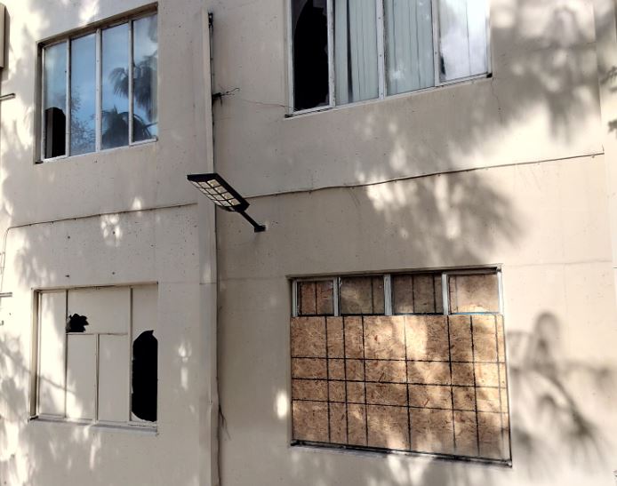 Windows are both broken and boarded up at the former Sakura Intermediate Care Facilith which has been occupied by squatters