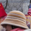 A woman walks by the Chinese and U.S. national flags on display outside a souvenir shop in Beijing on Jan. 31, 2025.