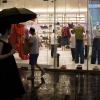 Chinese customers stroll past a clothing shop at Taikoo Li Sanlitun in Beijing. China's powerful Politburo has endorsed the ruling Communist Party's strategy for growing the economy by encouraging more consumer spending and weeding out unproductive companies to promote "survival of the fittest."
