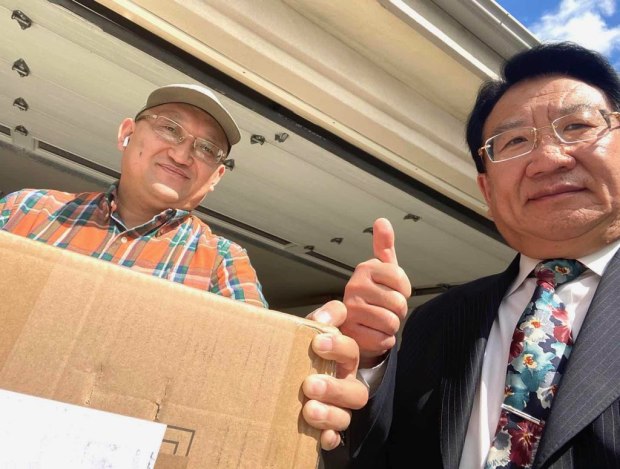 Henry Miao, left, prepares to ship a box of masks with West Covina Mayor Tony Wu. Miao, who owns Henrial, donated thousands of masks to the City of West Covina and distributed to healthcare and frontline workers in the community. (Photo courtesy of Henry Miao)